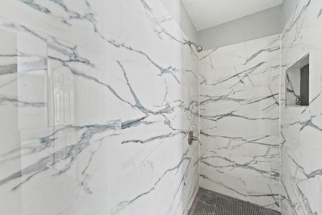 bathroom with a marble finish shower