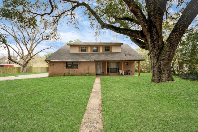 view of front of home featuring fence, a porch, and a front lawn