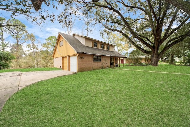 view of side of home featuring driveway, a yard, brick siding, and a garage