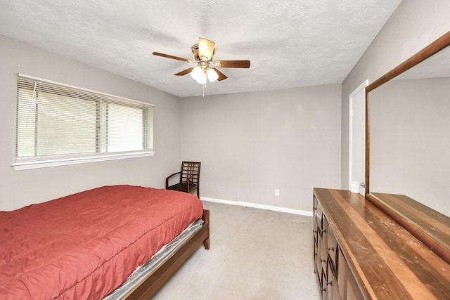 bedroom with a textured ceiling, ceiling fan, carpet flooring, and baseboards
