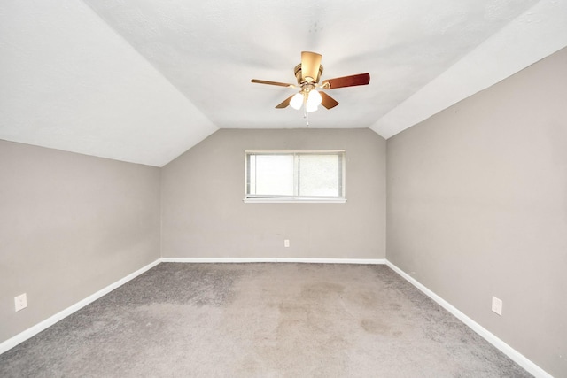 bonus room with a ceiling fan, carpet flooring, vaulted ceiling, and baseboards