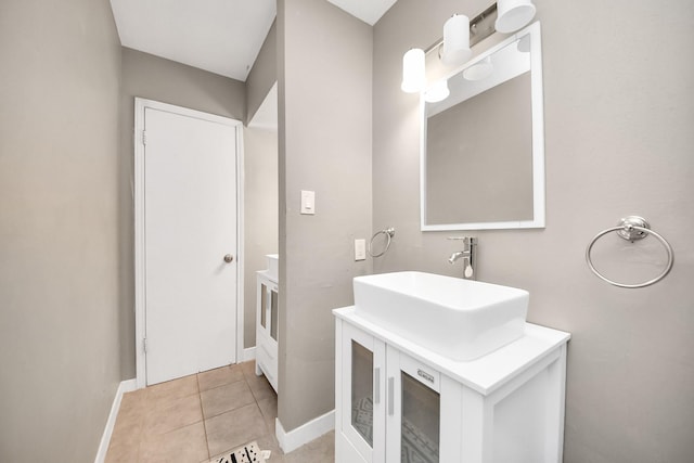 bathroom with baseboards, tile patterned floors, and vanity