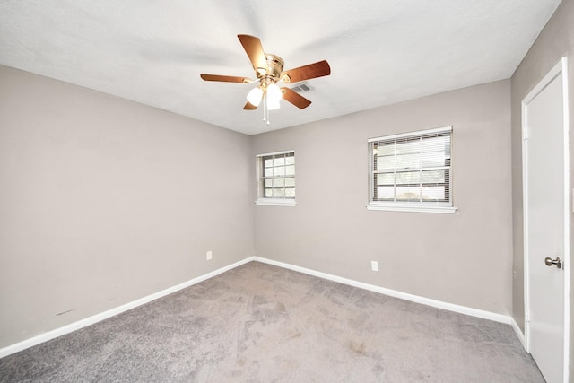 unfurnished bedroom featuring carpet floors, ceiling fan, visible vents, and baseboards
