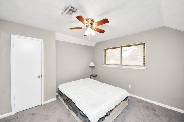 bedroom with vaulted ceiling, carpet flooring, baseboards, visible vents, and a ceiling fan