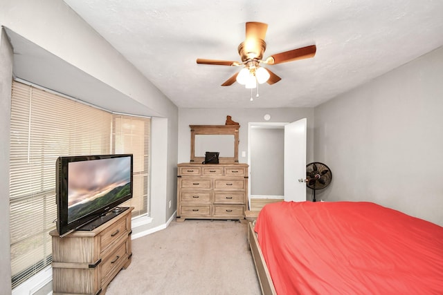 bedroom featuring baseboards, a ceiling fan, and light carpet
