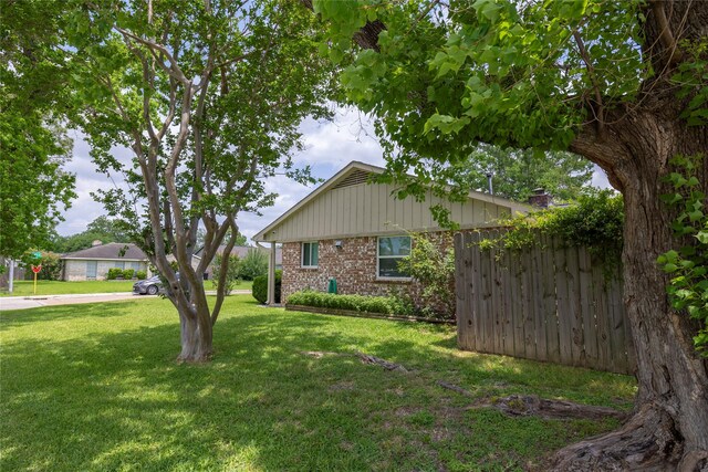 view of home's exterior featuring a lawn and brick siding
