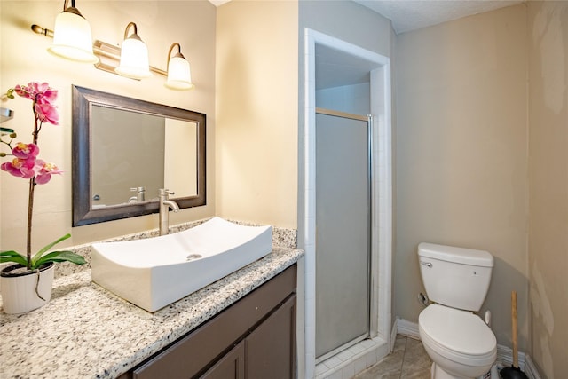 full bath with vanity, toilet, a shower stall, and baseboards