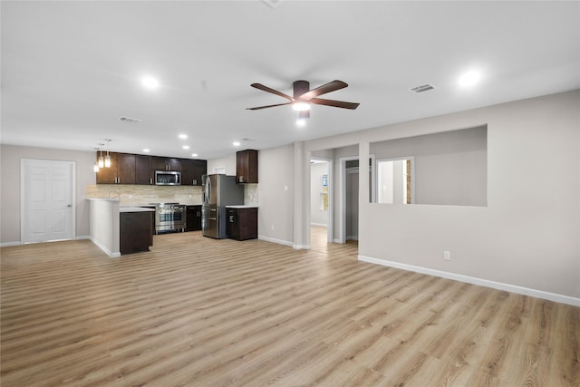 unfurnished living room with baseboards, visible vents, light wood finished floors, and recessed lighting
