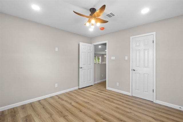 unfurnished bedroom featuring light wood finished floors, visible vents, and baseboards