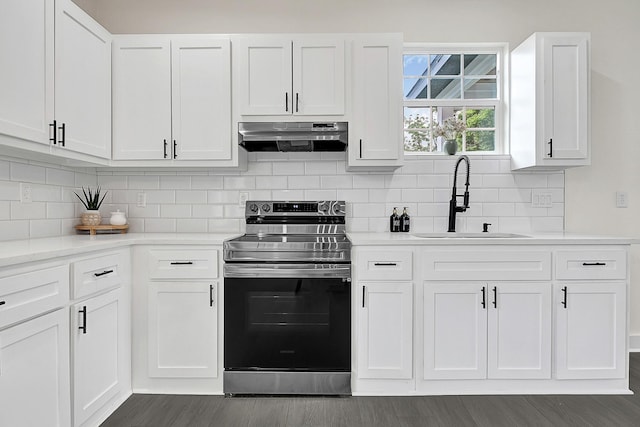 kitchen featuring stainless steel electric range, a sink, light countertops, dark wood finished floors, and under cabinet range hood