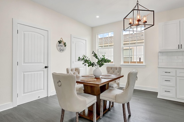dining area with dark wood-type flooring, recessed lighting, baseboards, and a notable chandelier