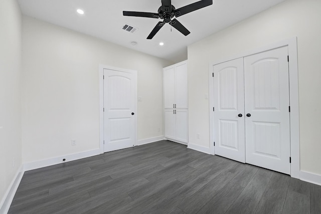 unfurnished bedroom with baseboards, visible vents, recessed lighting, and dark wood-type flooring