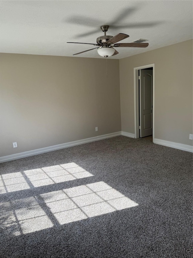 carpeted empty room featuring a ceiling fan and baseboards