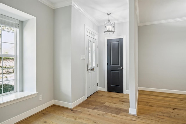3708 Lake St, Houston, TX 77098 - entrance foyer featuring a chandelier, crown molding, baseboards, and light wood-style floors