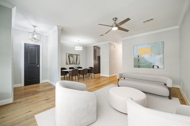 3708 Lake St, Houston, TX 77098 - living room with visible vents, crown molding, and light wood finished floors