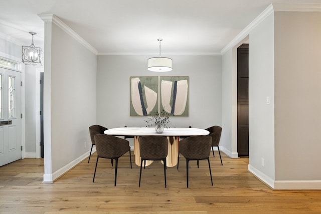 3708 Lake St, Houston, TX 77098 - dining area featuring crown molding, light wood-type flooring, a notable chandelier, and baseboards