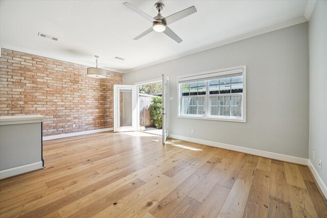 3708 Lake St, Houston, TX 77098 - unfurnished living room featuring crown molding, visible vents, ceiling fan, and brick wall