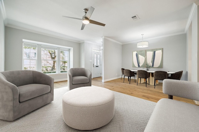 3708 Lake St, Houston, TX 77098 - living area with crown molding, visible vents, baseboards, and light wood-style floors