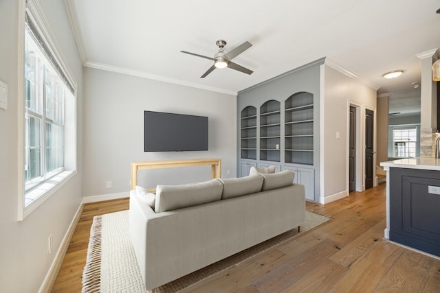 3708 Lake St, Houston, TX 77098 - living area featuring crown molding, light wood-style floors, and baseboards