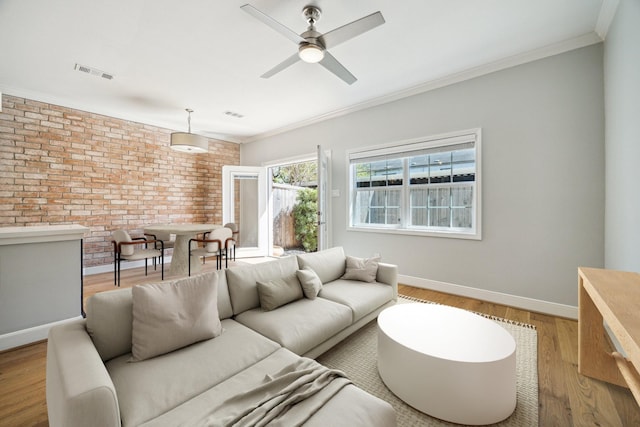 3708 Lake St, Houston, TX 77098 - living area with visible vents, a ceiling fan, crown molding, and brick wall