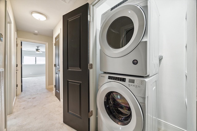 3708 Lake St, Houston, TX 77098 - clothes washing area with ceiling fan, stacked washer and clothes dryer, laundry area, light carpet, and baseboards