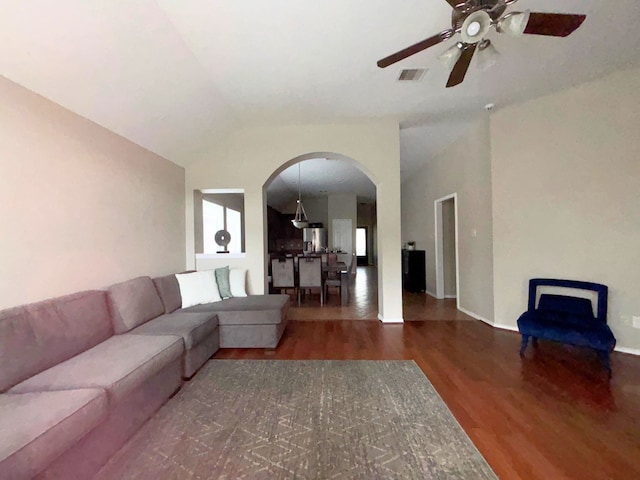 4326 Sunlit Pass Loop, Humble, TX 77396 - living room featuring visible vents, arched walkways, vaulted ceiling, wood finished floors, and a ceiling fan