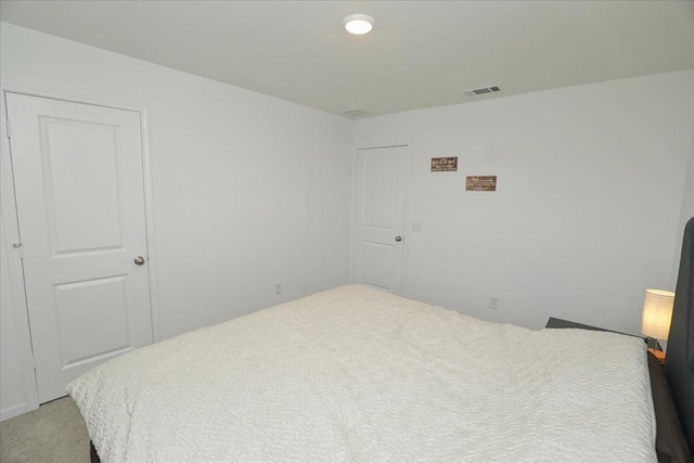 unfurnished bedroom with visible vents and light colored carpet