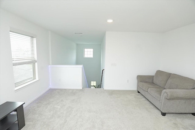 living area with light colored carpet, visible vents, recessed lighting, and baseboards