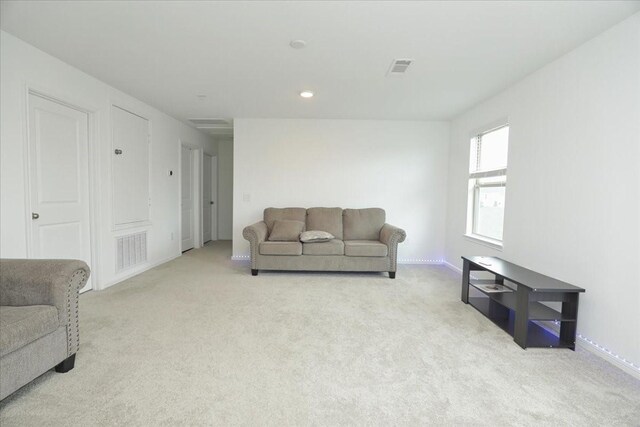 living room with light colored carpet, visible vents, and recessed lighting