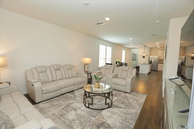 living area featuring wood finished floors, visible vents, and recessed lighting