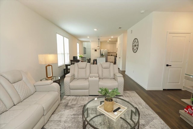 living room with recessed lighting, baseboards, and dark wood finished floors