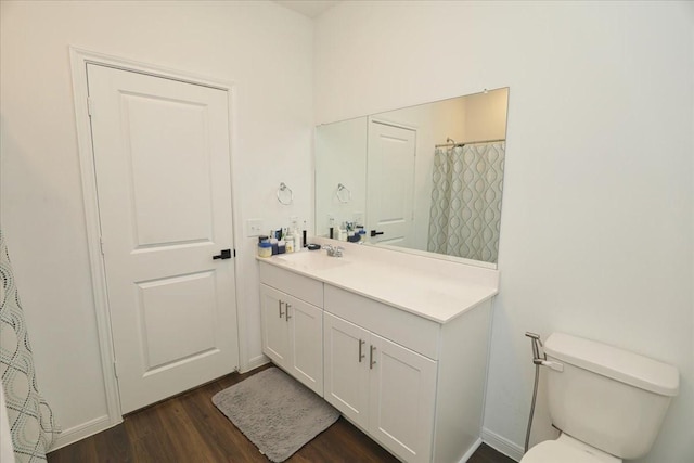 full bathroom featuring toilet, vanity, and wood finished floors
