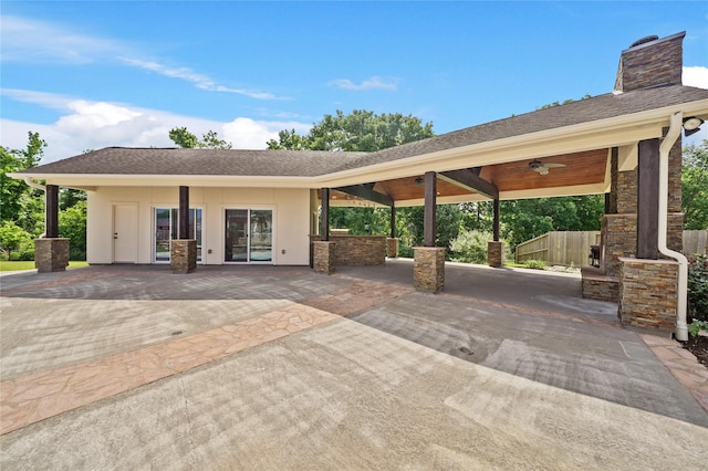 view of patio / terrace featuring a ceiling fan, exterior kitchen, and fence