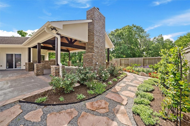 view of patio featuring exterior kitchen and fence