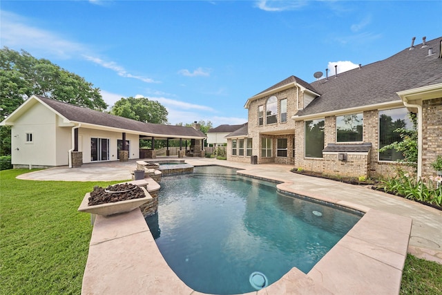 view of swimming pool with a yard, a patio, and a pool with connected hot tub