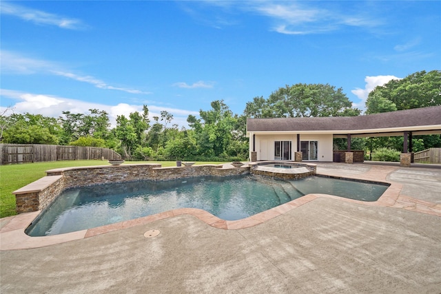 view of pool featuring a yard, a patio, a pool with connected hot tub, and fence private yard