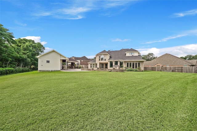 back of house with a yard, a patio, and a fenced backyard