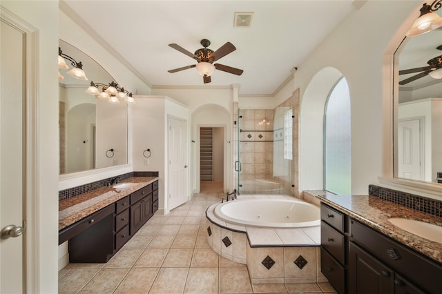 full bathroom featuring a tub with jets, ceiling fan, a shower stall, and a sink