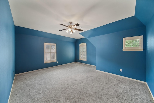 carpeted empty room featuring baseboards and ceiling fan