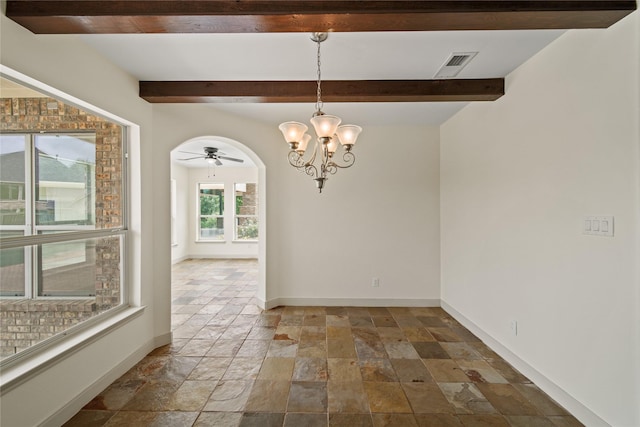 unfurnished dining area featuring beam ceiling, arched walkways, stone tile floors, baseboards, and visible vents