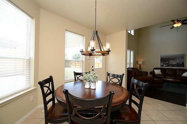 5002 Hearth Hollow Ln, Sugar Land, TX 77479 - dining space featuring baseboards, ceiling fan with notable chandelier, light tile patterned floors, and a wealth of natural light