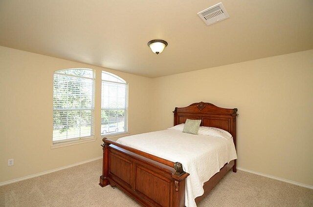 5002 Hearth Hollow Ln, Sugar Land, TX 77479 - bedroom with baseboards, multiple windows, light carpet, and visible vents