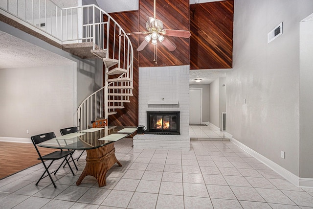 13126 Birch Grove Dr, Houston, TX 77099 - living room featuring stairway, visible vents, tile patterned flooring, and a high ceiling