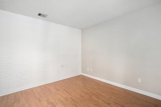 13126 Birch Grove Dr, Houston, TX 77099 - spare room featuring a textured ceiling, visible vents, wood finished floors, and baseboards