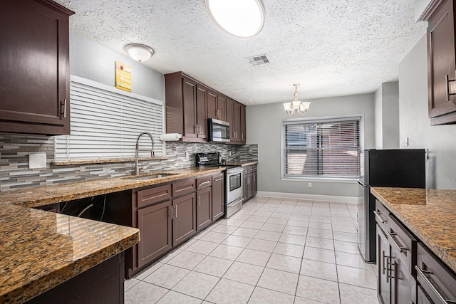 13126 Birch Grove Dr, Houston, TX 77099 - kitchen featuring light tile patterned floors, decorative backsplash, a sink, visible vents, and stainless steel appliances