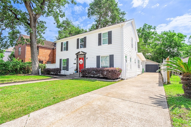 3210 Oakdale St, Houston, TX 77004 - view of front of house with an outdoor structure, a detached garage, and a front yard
