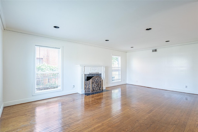 3210 Oakdale St, Houston, TX 77004 - unfurnished living room with baseboards, visible vents, ornamental molding, and wood-type flooring