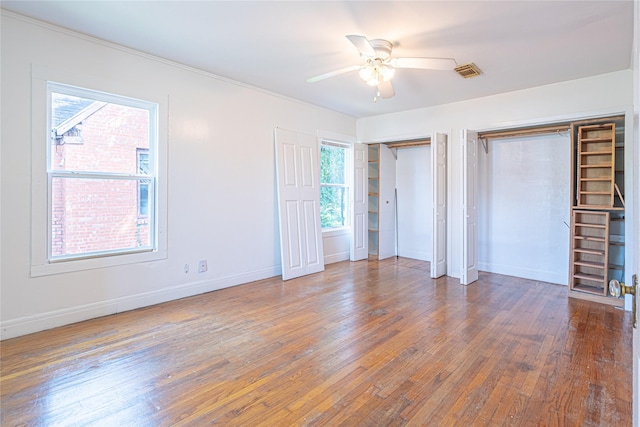 3210 Oakdale St, Houston, TX 77004 - unfurnished bedroom featuring hardwood / wood-style floors, visible vents, two closets, and baseboards