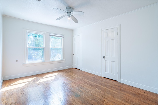 3210 Oakdale St, Houston, TX 77004 - unfurnished bedroom featuring wood finished floors, two closets, and baseboards