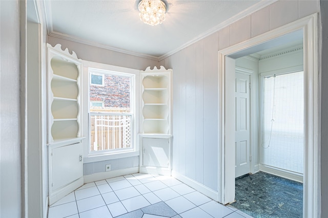3210 Oakdale St, Houston, TX 77004 - interior space with an inviting chandelier, tile patterned floors, crown molding, a decorative wall, and baseboards